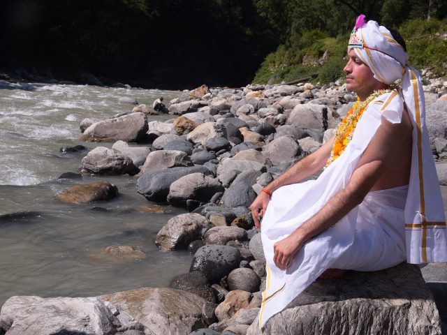 Person doing meditation at ganga in rishikesh